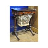 A Victorian rosewood work table, having a frieze drawer and pull out workbag,