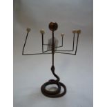 A brass tabletop oriary, on a coiled snake support,