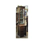 An inlaid mahogany cabinet, of tall slender proportions, the bar glazed door above four drawers,