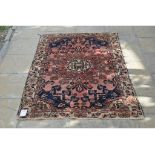 An eastern rug, decorated floral motifs on a blue ground, within a multi border,
