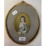 An oval half length portrait miniature, of a young boy, watercolour on ivory, indistinctly signed,