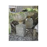 A pair of reconstituted stone garden urns and stands, 66 cm high,