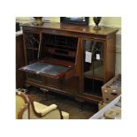 An early 20th century mahogany bookcase, with a central bureau section,