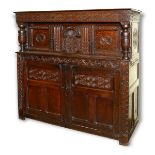A carved oak court cupboard, of traditional design, 18th century, carving probably later,