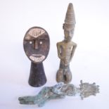 An Egyptian cast metal figure, 20 cm high, and two other African figures,