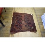 An Afghan rug, decorated geometric motifs on a red ground, within a multi border, 98 x 102 cm,