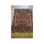 A Persian Shiraz rug, with geometric motifs on an orange ground,