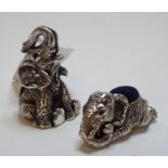 A silver coloured metal novelty pincushion, in the form of a seated elephant, 4.