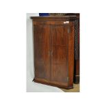 A 19th century inlaid mahogany hanging corner cupboard,