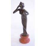 An Art Nouveau style bronze figure, on a stand,