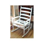 A rocking armchair, a pine dining table, a matching set of four chairs, a spinning chair,