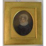 An oval half length portrait miniature, of a lady wearing a lace bonnet and collar, pencil, 12 x 9.