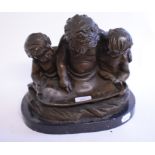 A bronze group, of three putti reading a scroll, on a marble base,