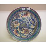 A Carter, Stabler & Adams Poole Pottery charger, decorated stylised flowers and foliage, SL/A (?),