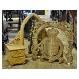 A carved coat of arms, 55 cm wide, and an oak mirror, with drawers, from a dressing table,