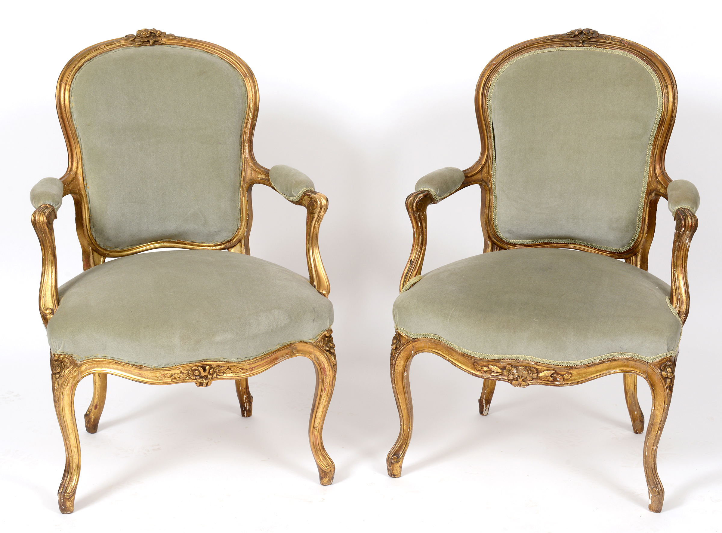 A pair of Louis XVI style French giltwood upholstered fauteil,