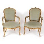 A pair of Louis XVI style French giltwood upholstered fauteil,