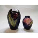 A Moorcroft pottery vase, decorated a single rose, on a blue ground, 12.