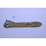 A large cigar cutter, the handle decorated with dogs hare coursing,