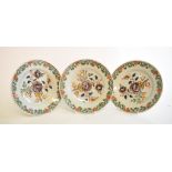 A set of three 19th century Dutch Delft polychrome plates, with floral decoration,