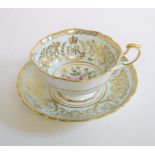 A Paragon Queen Elizabeth II commemorative cup and saucer, a pair of iron fire dogs, 31 cm high,