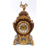 A Louis XVI style mantel clock, the 10 cm diameter brass dial with Roman numerals on enamel tablets,
