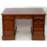 A late Victorian Hindley walnut desk, the leather inset top above an arrangement of nine drawers,