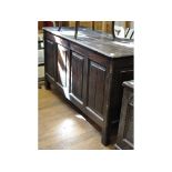 An oak coffer, with a four panel front,