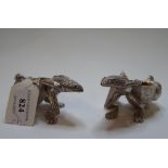 A pair of plated salts, in the form of frogs pulling shells,