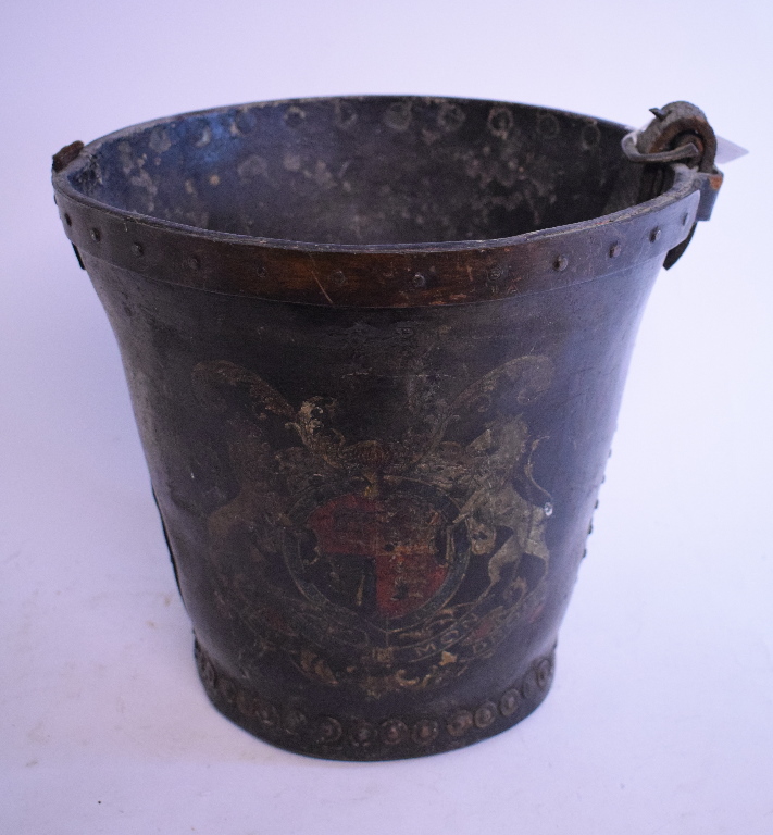 A leather fire bucket, painted a crest, handle broken,