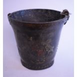 A leather fire bucket, painted a crest, handle broken,