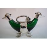 A green glass double decanter, in the form of a duck, with plated mounts,