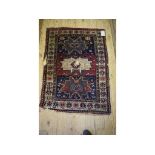 A Caucasian rug, decorated geometric motifs on a black ground within a multi border,