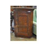 A pine hanging corner cupboard,