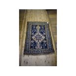 A Persian rug, decorated motifs and figures, within a multi border,