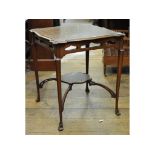 An Edwardian inlaid walnut two tier occasional table, the frieze pierced hearts,