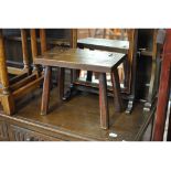 A Victorian elm stool, a nest of three oak occasional tables, a tripod table, a Pembroke table,