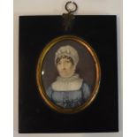 An oval bust portrait miniature, of a lady wearing a mop cap, watercolour,