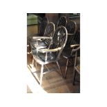 A set of seven kitchen wheel back chairs,