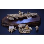 A Japanese carved ivory group, of figures attacking a crocodile, with character mark to base, 20.