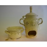 A Leeds Creamware Veilleuse teapot and cover, on stand, with mask decoration, 28 cm high,