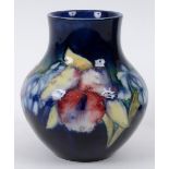 A Moorcroft pottery Orchid vase, with W Moorcroft Potter To H M The Queen stamp to base,
