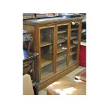 A late Victorian oak bookcase, with three doors,