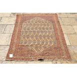 A Persian style rug, decorated boteh within a multi border,