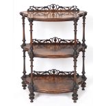 A Victorian burr walnut three tier whatnot, on turned and carved supports,