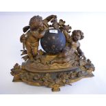 A late 19th century gilt spelter mantel clock, the movement set within a sphere,