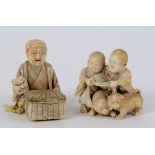 A 19th century Japanese carved ivory group, of two children and two puppies, character mark to base,