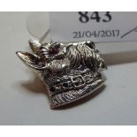 A silver coloured metal Scottie dog brooch, set ruby and emerald,