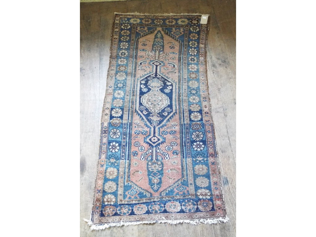 A Persian rug, decorated geometric motif