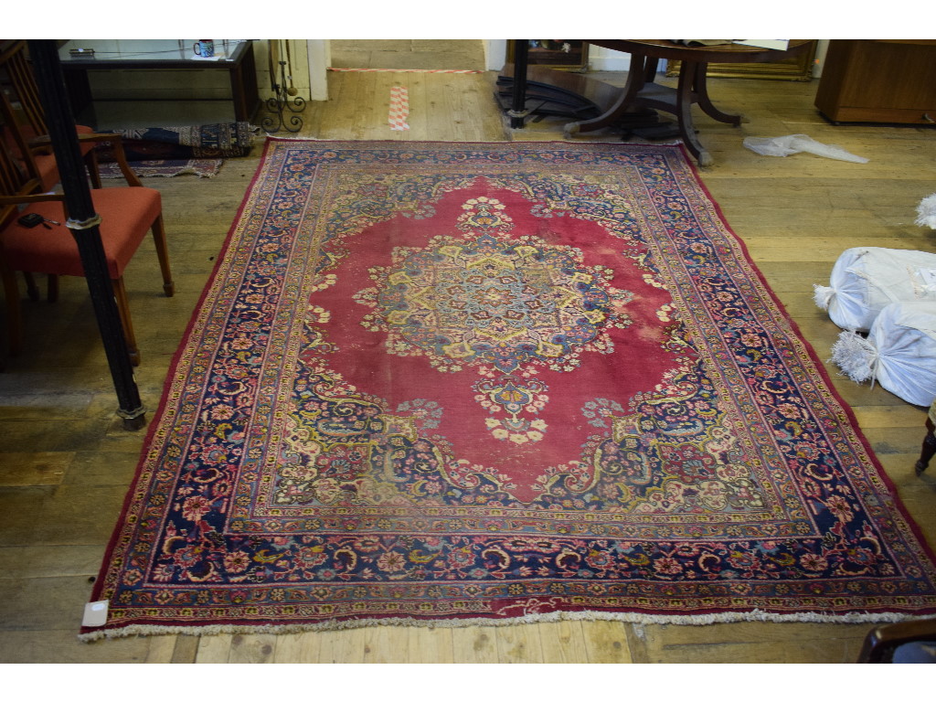 A Persian carpet, decorated a central lo